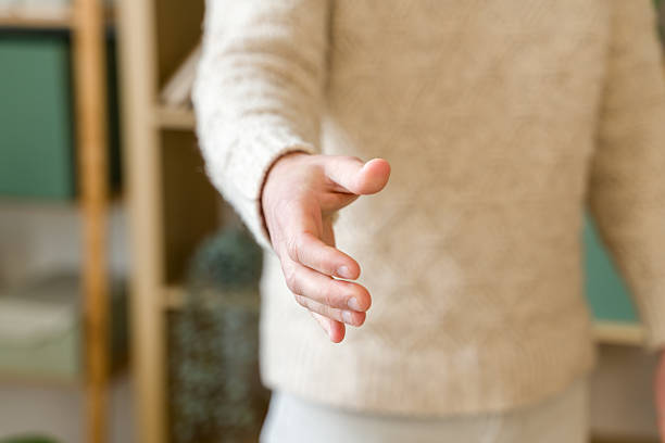 istock Businessman extending hand for handshake in office 2209396817