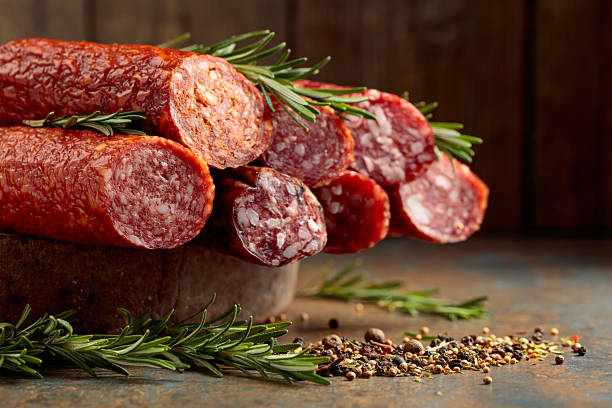 istock Smoked and dry cured sausages on a rustic background. 2209396842