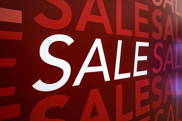 istock Bold red sale sign displayed prominently on retail store window 2209397264
