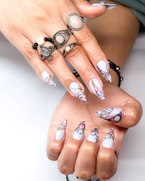 istock Artfully adorned hands featuring bracelets, rings, and beautifully painted nails. 2209399076