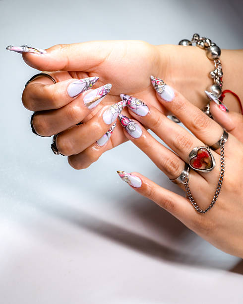 istock Artfully adorned hands featuring bracelets, rings, and beautifully painted nails. 2209399102