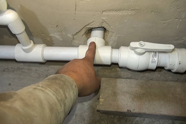 istock the plumber points with his hand at an element of the heating pi 2209399784