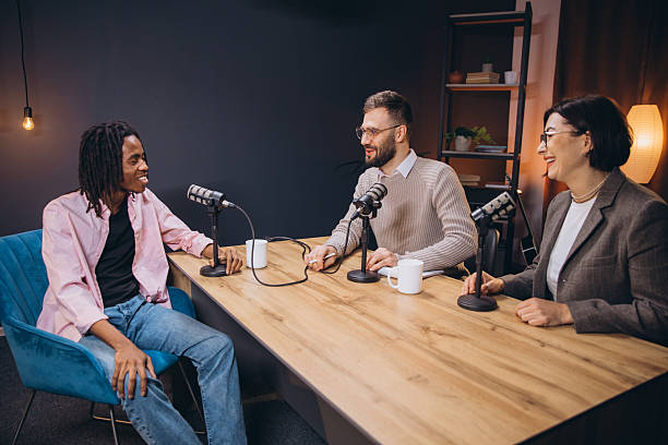 istock Podcasters talking during a recording session, using professional microphones and audio equipment in a modern studio 2209402756