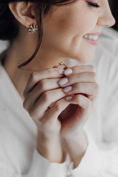 istock A woman is holding a ring in her hand and smiling 2209402903