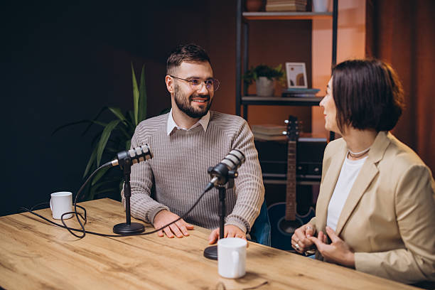 istock Podcasters recording professional studio content, speaking passionately while wearing headsets and microphones 2209403058