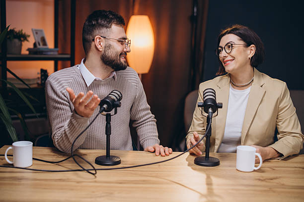 istock Two podcasters are recording an episode in a professional studio, engaging in conversation and sharing their insights with their audience 2209403098