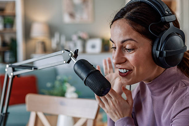 istock Joyful woman recording live podcast 2209403410