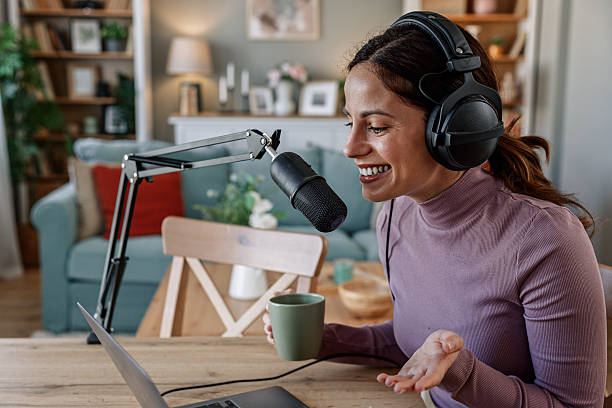 istock Joyful woman recording live podcast 2209403432