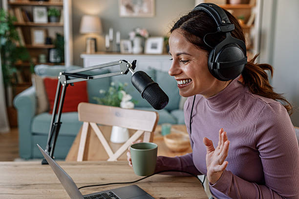 istock Joyful woman recording live podcast 2209403444