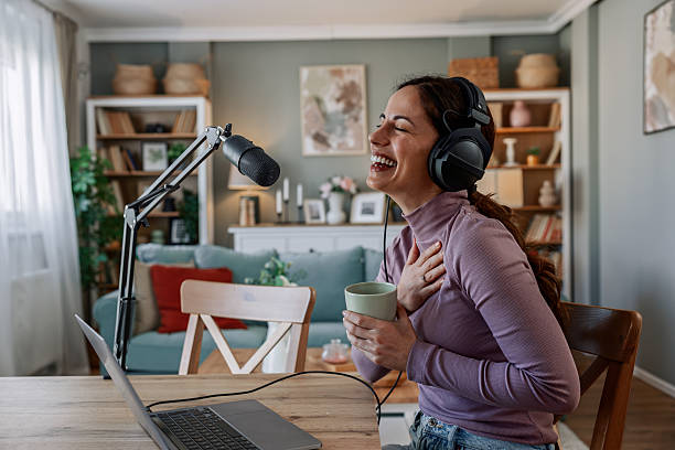 istock Joyful woman recording live podcast 2209403465