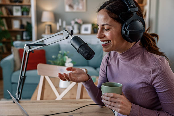 istock Joyful woman recording live podcast 2209403509