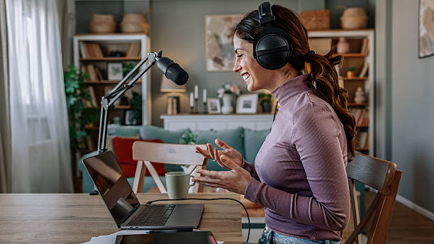istock Joyful woman recording live podcast 2209403625