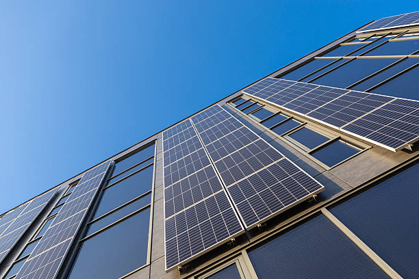 istock Modern building with installed solar panels on facade for renewable energy and sustainability under clear blue sky low angle view eco friendly architecture 2209404773