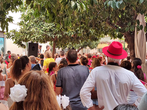 Crowd of people enjoying party on the streets of Malaga for the Feria de Agosto 2024 (August Fair) or Feria de Málaga, a street fair that takes place every August. Andalusia, Spain.