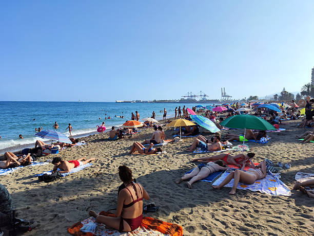 People sunbathing at Playa de la Malagueta, a beach in the Centro district of the city of Málaga, in Andalusia, Spain. It is an popular urban beach about 1200 meters long.