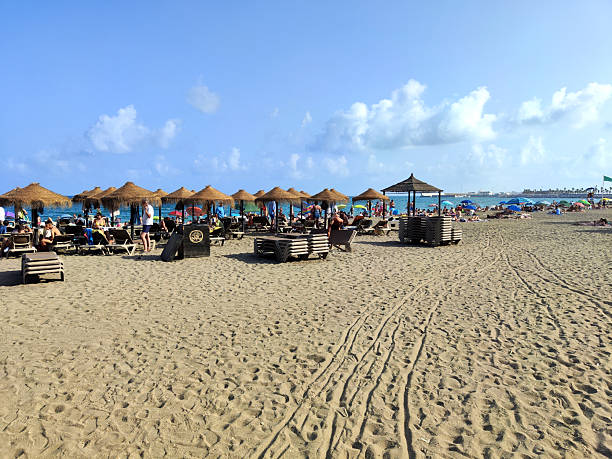 People sunbathing at Playa de la Malagueta, a beach in the Centro district of the city of Málaga, in Andalusia, Spain. It is an popular urban beach about 1200 meters long.