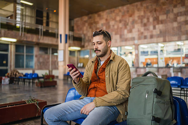 istock man tourist use mobile phone for research and fun on train station 2209409760