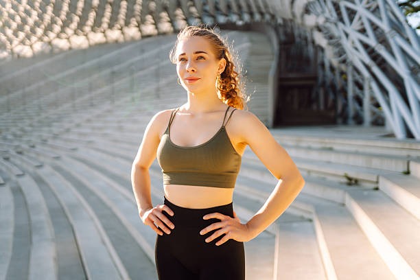 istock Sporty woman doing exercises at sunset. 2209411736