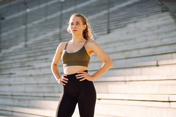 istock Sporty woman doing exercises at sunset. 2209411741