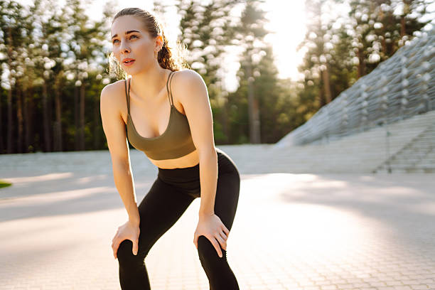 istock Sporty woman doing exercises at sunset. 2209411745