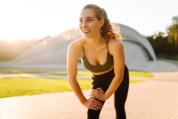 istock Sporty woman doing exercises at sunset. 2209411755