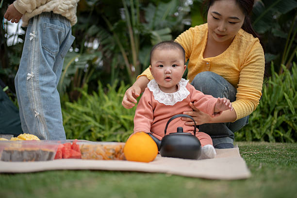 Mother camping outdoors with baby