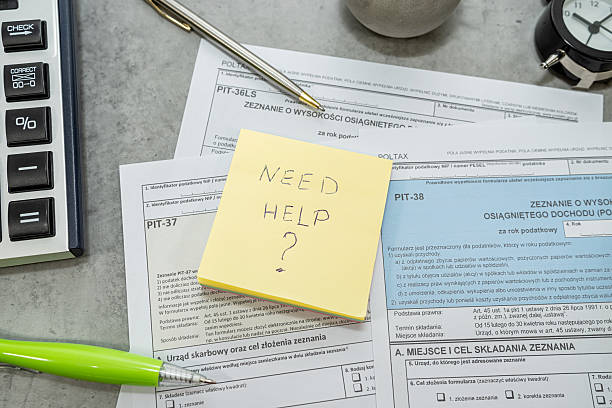 istock Text Need help on sticker Annual tax polish tax forms PIT-36 PIT-37 PIT-38 with pen calculator. 2209414362