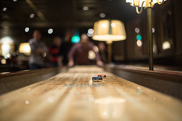 istock Shuffleboard game in dimly lit bar.. 2209416020