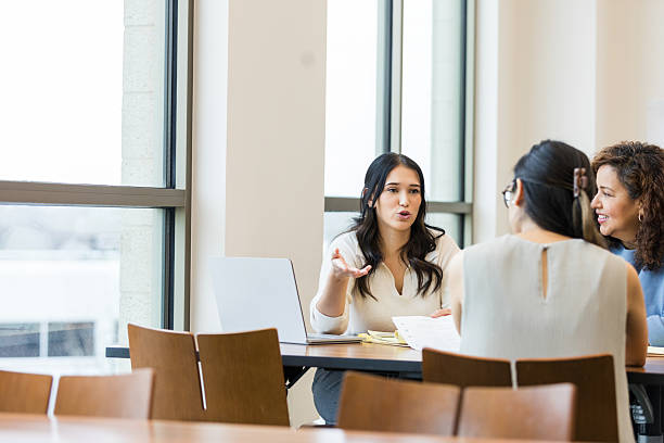 istock Three Diverse Women in a Business Meeting, Discussing Ideas 2209416402