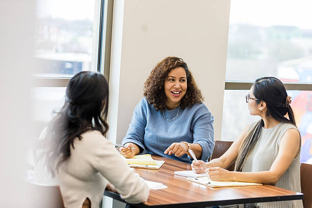 istock Three diverse women in casual clothing having a discussion 2209416403