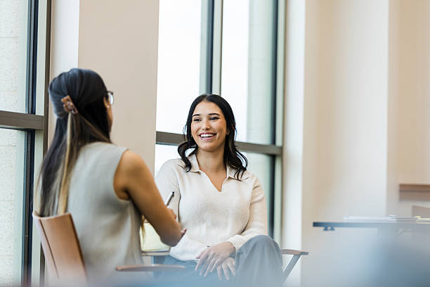 istock Two Women in Casual Clothing Having a Discussion 2209416408