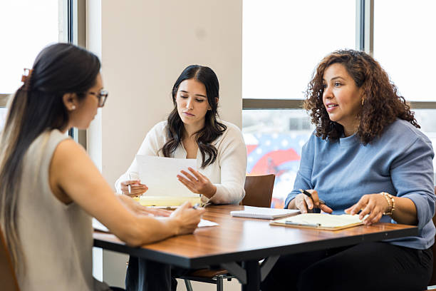 istock Three Women in a Business Meeting Discussing Documents 2209416417