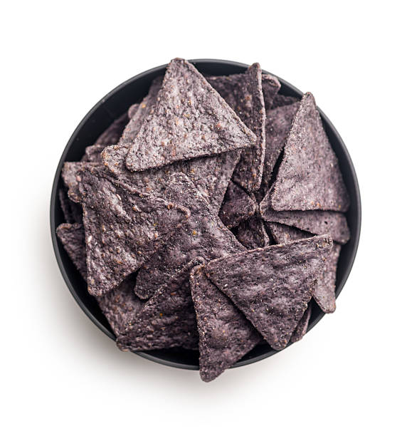 istock Dark nachos chips in bowl isolated on white background. 2209417923