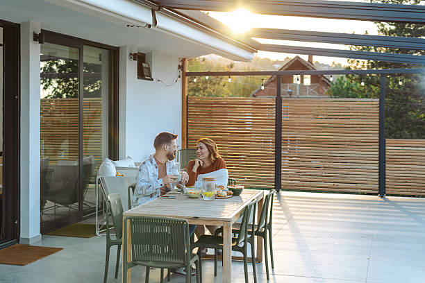 istock Couple enjoying breakfast on a modern terrace during a sunny morning 2209417966