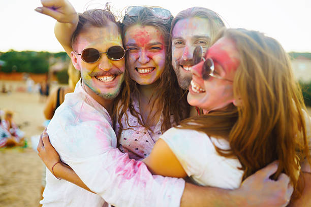 istock Happy friends having fun on the sunset beach. 2209418023
