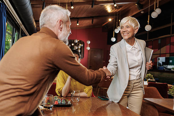 istock Business professionals greeting each other during a meeting in a restaurant setting 2209419443