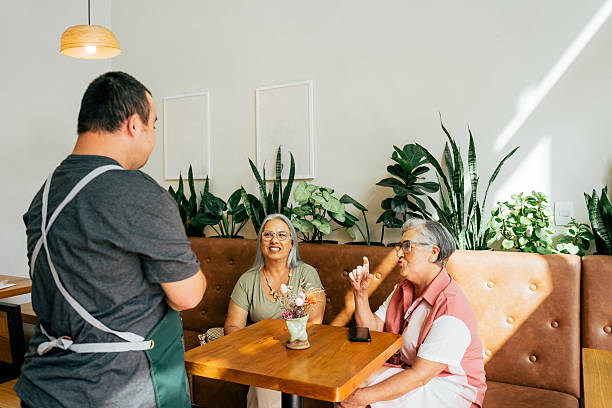 istock Man with down syndrome taking order in coffee shop, working as waiter 2209425228