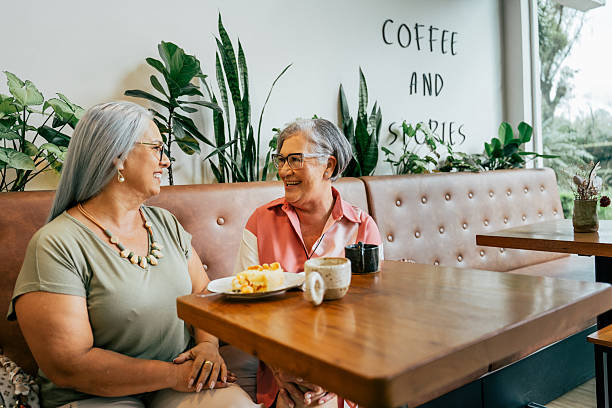 istock Two female friends chatting while drinking coffee in a cafe 2209425261