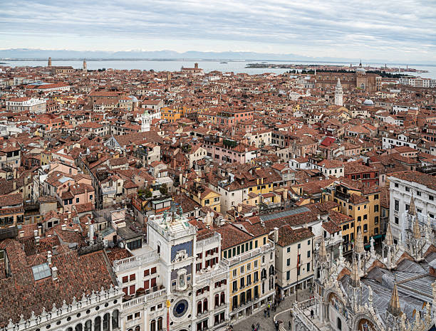 Glimpse of St Mark's Basilica and St Mark's Campanile seen from Venice rooftops, Italy
