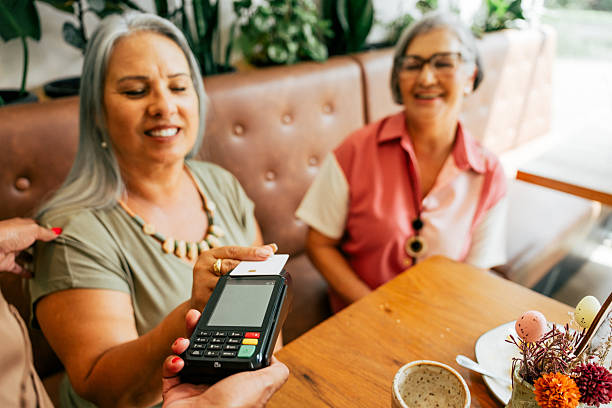 istock Women making contactless payment at coffee shop 2209426069
