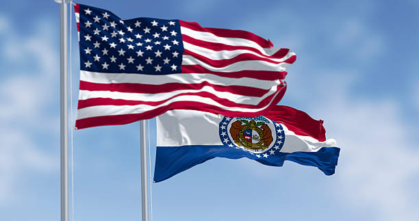 istock Missouri and American flags waving together in wind, 3D render 2209427017