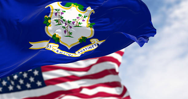 istock Connecticut state flag waving with American flag in background, 3D render 2209427052