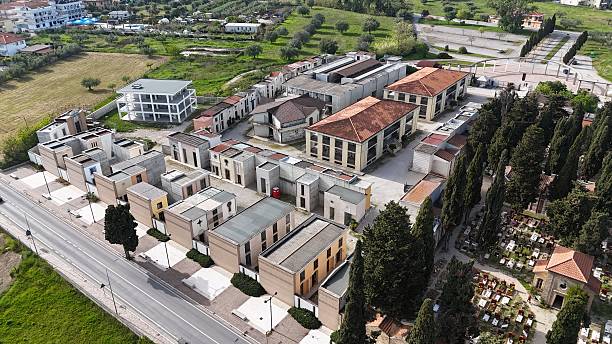 istock This aerial view captures a modern Italian cemetery, featuring an array of distinct mausoleums and tombs nestled among cypress trees, revealing organized pathways and a solemn, architectural landscape. 2209429659