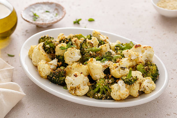istock Roasted broccoli and cauliflower on a serving plate with herbs and spices 2209429745