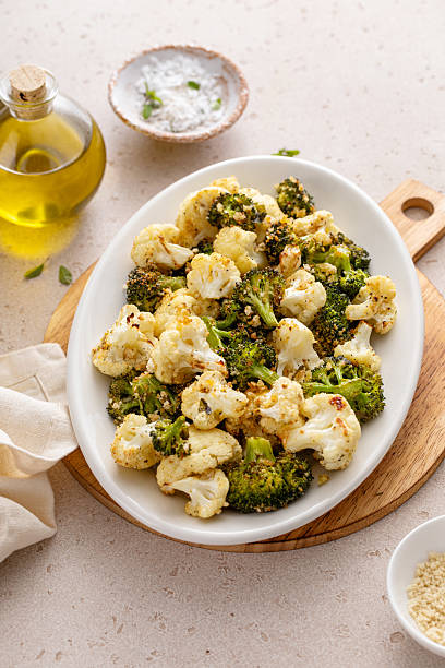 istock Roasted broccoli and cauliflower on a serving plate with herbs and spices 2209429751