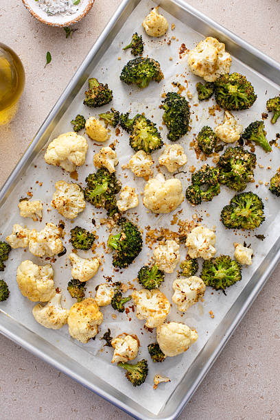 Broccoli and cauliflower roasted on a baking sheet with herbs