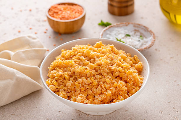 istock Cooked red lentils in a bowl, vegan protein source 2209429760