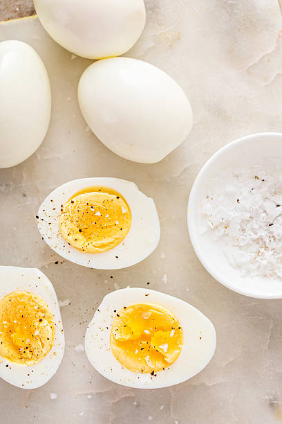 istock Soft boiled eggs cut in half with salt and pepper 2209429799
