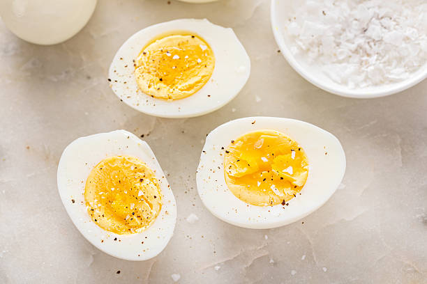 istock Soft boiled eggs cut in half with salt and pepper 2209429804