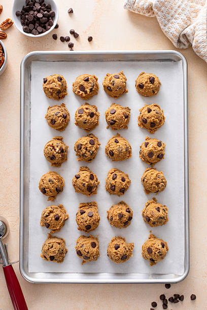 istock Chocolate chip cookies with pecan nuts, cookie dough ready on a baking sheet 2209429851
